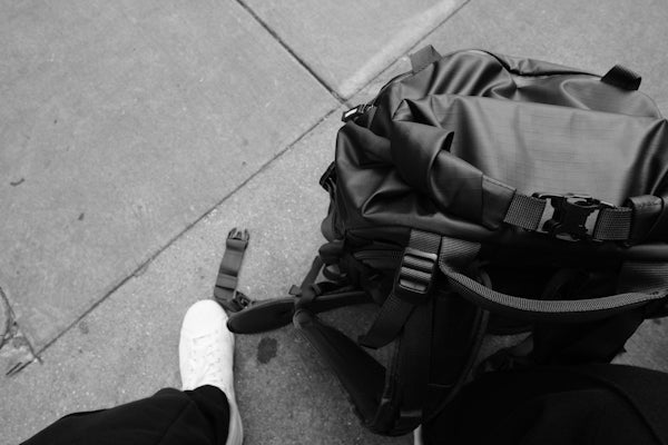 a black and white photo of a person with a backpack