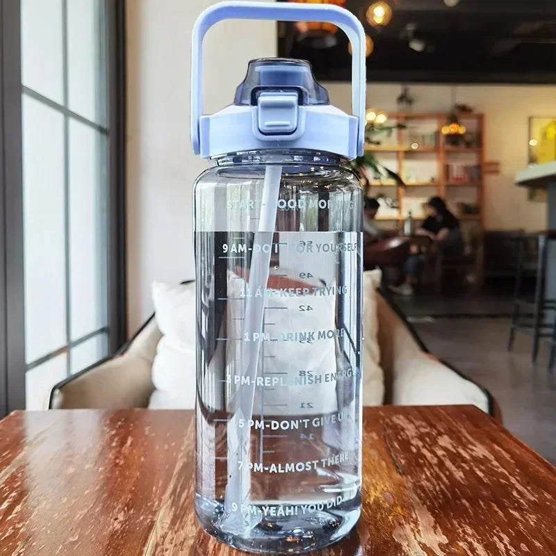Valour Fit 2L motivational sports water bottle with time marker, clear plastic with measurement lines and ergonomic design.