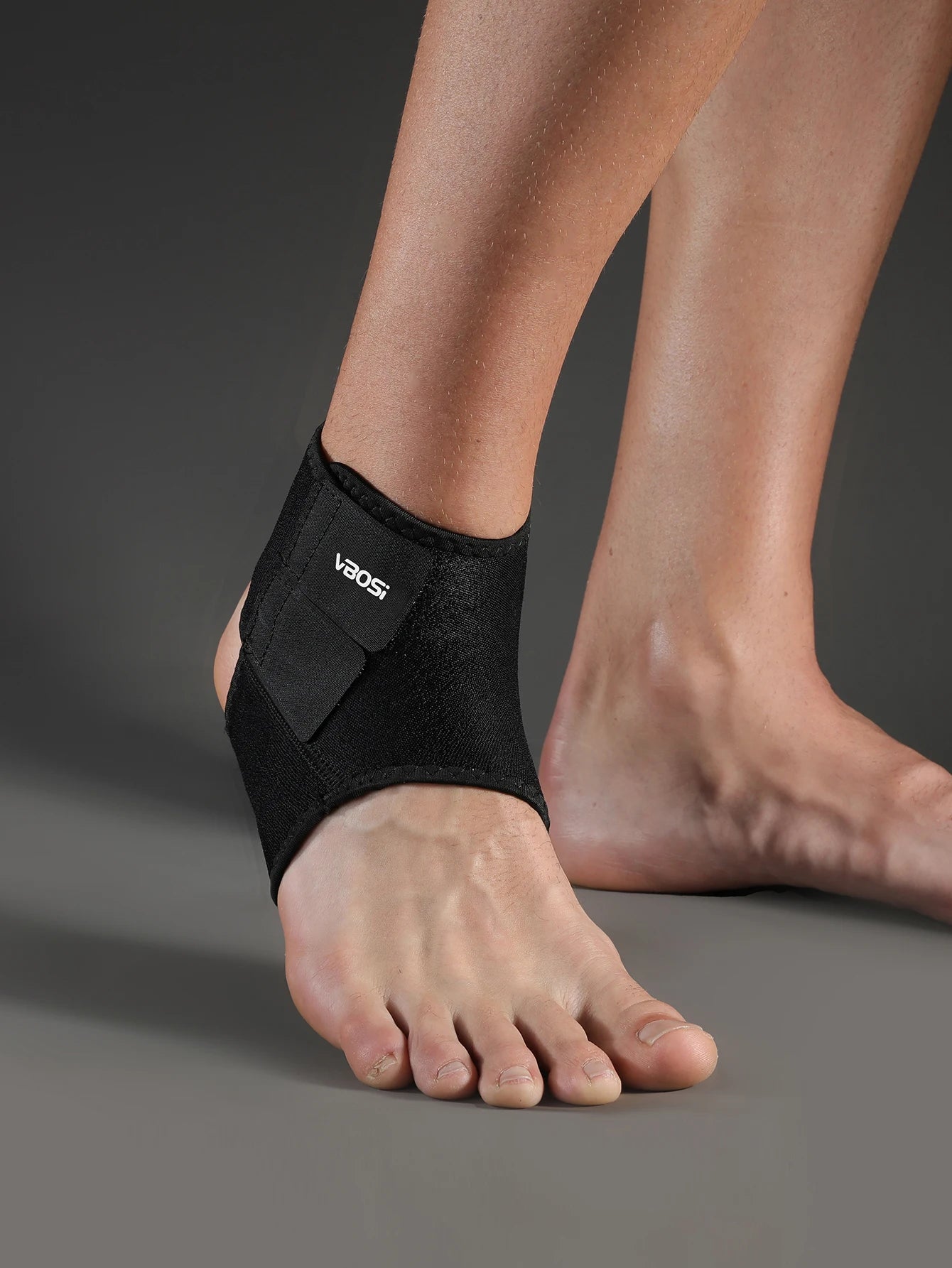 Valour Fit adjustable ankle support sleeve for sports and daily use, shown on a person's ankle with a snug fit.