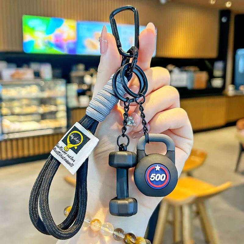 Valour Fit fitness keychain with D-shaped clip attached to a gym bag for secure fitness accessories.