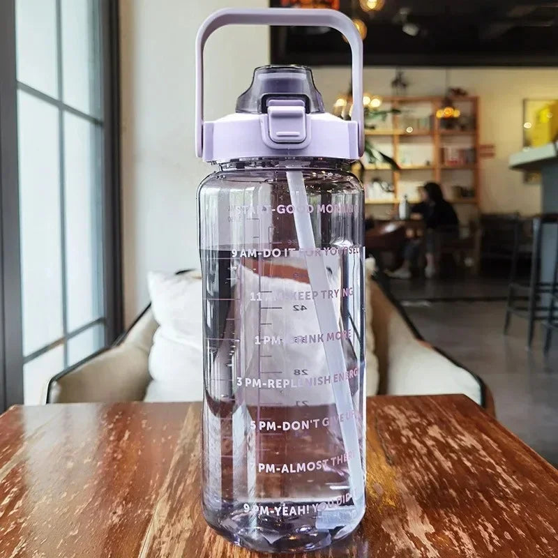 Valour Fit 2L straw water bottle with time marker, clear plastic design, and ergonomic lid for easy hydration.