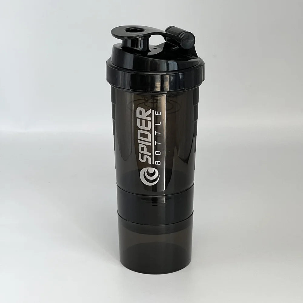 Valour Fit 3-layer protein shaker bottle with storage compartments, white and blue design, featuring a secure lid and mixing mechanism.