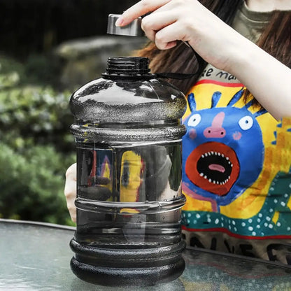 Valour Fit 2L PETG gym water bottle with carry handle, clear plastic design, and ergonomic grip for fitness hydration.