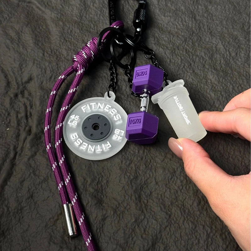 Valour Fit fitness keychain with D-shaped clip, designed for gym bags and fitness accessories, in black with a sleek metal finish.