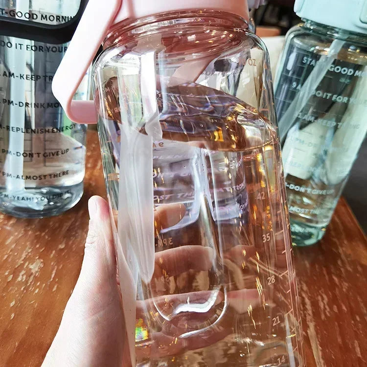 Valour Fit 2L motivational sports water bottle with time marker and ergonomic lid design for easy hydration.