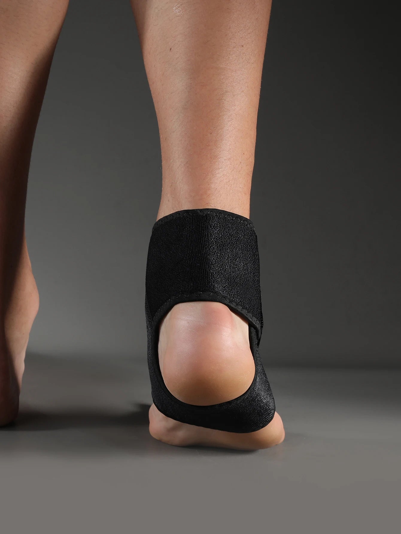 Valour Fit adjustable ankle support sleeve for sports and daily use, shown in black with breathable fabric and secure fit.