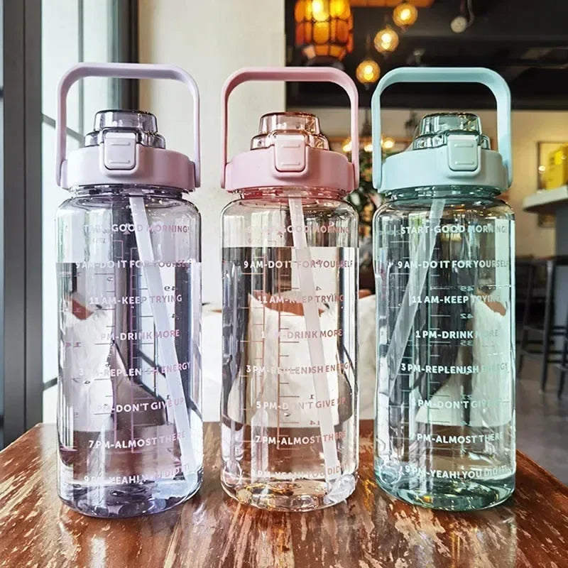 Valour Fit 2L straw water bottle with time marker, clear plastic with flexible straw and measurement markings for hydration tracking.
