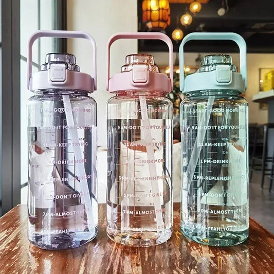 Valour Fit 2L straw water bottle with time marker, clear plastic with flexible straw and measurement markings for hydration tracking.